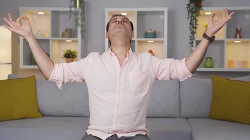 Man Meditating at Home in Yoga Pose