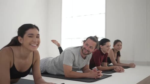 Group of people play yoga.