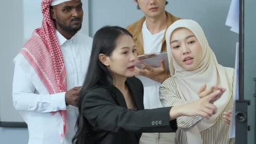 Diverse team collaborates on project in modern office