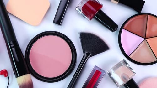 Rotierender Hintergrund mit dekorativer Kosmetik Rouge Concealer Puder Schatten Nagellack Make-up