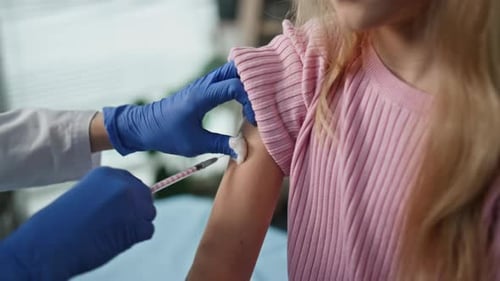 Child Getting Vaccine at Doctor's Office Close Up