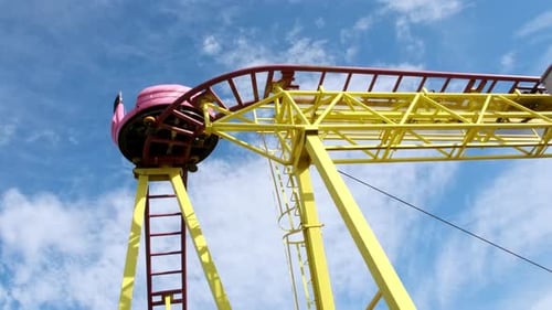 Top Down View of Roller Coaster Trolley at Amusement Park Against Blue Sky