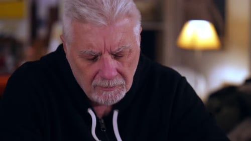 portrait of depressive man alone at home