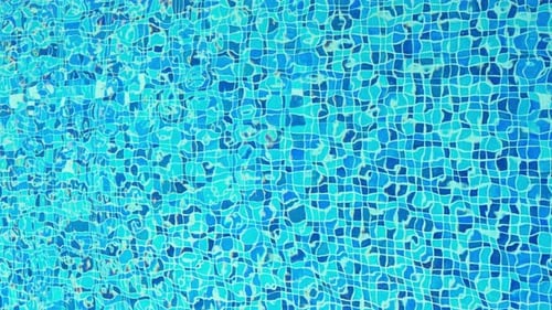 The View of Swimming Pool Water Surface at Sunset Sun Reflection