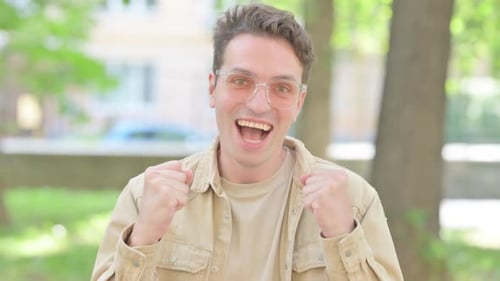 Excited Man Expressing Happiness Outdoors During the Day