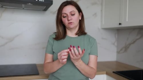 Woman Talking About Handcare in Kitchen Setting