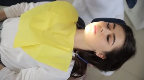 A Female Dentist Examines a Patient in a Dental Chair Polishing and Whitening of Teeth