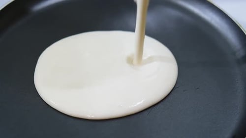 Pancake Batter Poured Into Frying Pan Close Up
