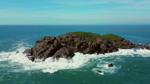 Aerial Slow Motion View of Waves Breaking Against Rocks on a Rocky Coastline Large Ocean Beautiful
