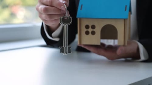 Real Estate Broker or Property Realtor Giving House Keys Close Up