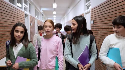 Students Walking and Talking in School Hallway