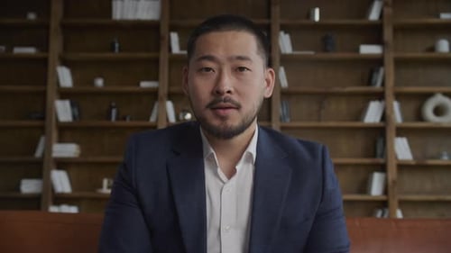 POV of an Asian Businessman Greeting on a Video Call in Loft Office Indoors in Slow Motion