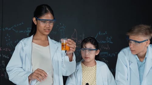 Students Conduct Science Experiment in Classroom Wearing Protective Gear