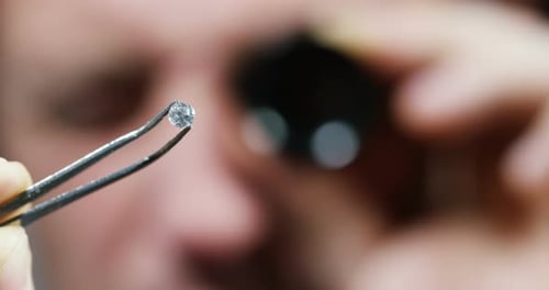 Close Up of Diamond Being Held in Tweezers