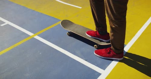 Man, skate and feet on skateboard in park, outdoor or training stunt, jump or skill in skatepark