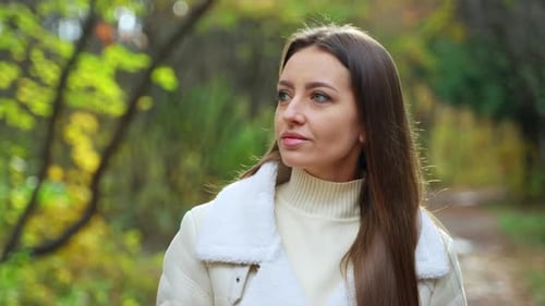 Woman with Coffee Walking in Woods