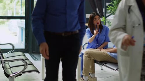 Nurse Talking to Patient With Neck Brace in Clinic