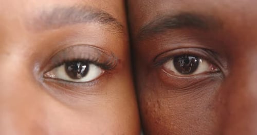 Close-up of young couple's eyes, showing intimacy and connection at home