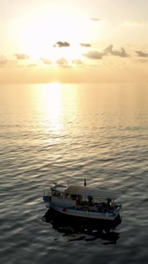 Vertical Video Aerial Wonderment Fishermen in Wooden Boat Cinematic Sunset HighQuality Video