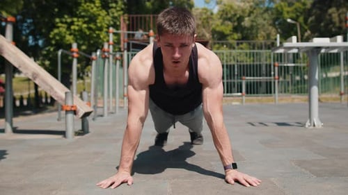 Fit Man Doing Push-Ups on Sunny Day