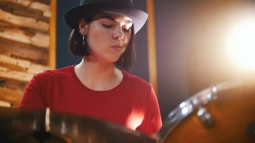 Repetition Girl in Black Hat Enthusiastically Plays the Drums Slow