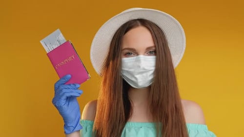 Woman with Mask Holding Passport and Tickets