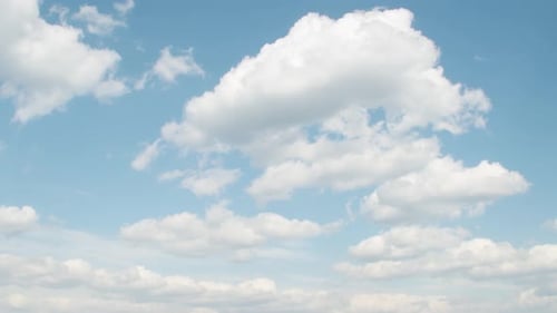 Fluffy White Clouds Floating in a Blue Sky