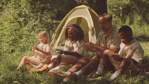 Father with Children Camping in Woods