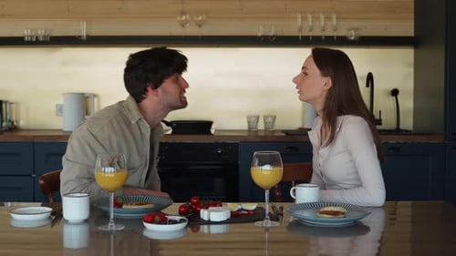 Young Couple Arguing During Breakfast in Kitchen