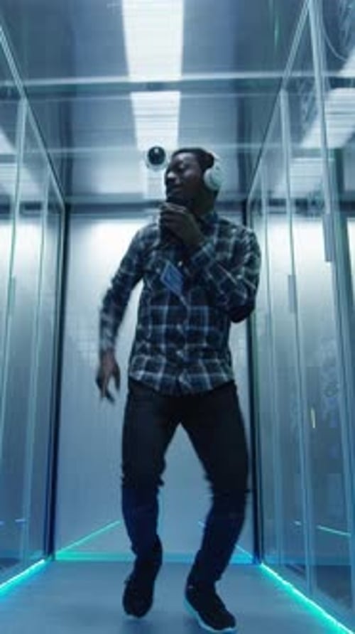Young Man Dancing Enthusiastically in Server Room