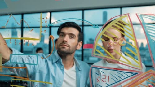 Team Brainstorming on Glass Whiteboard in Modern Office