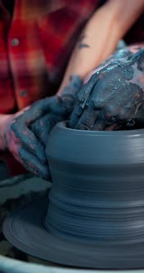 Hands Forming Clay Vase on Pottery Wheel