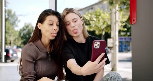 Young Women Using Smartphone on Street