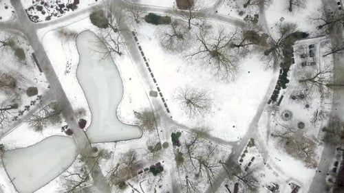 Aerial shot of an urban park covered in snow