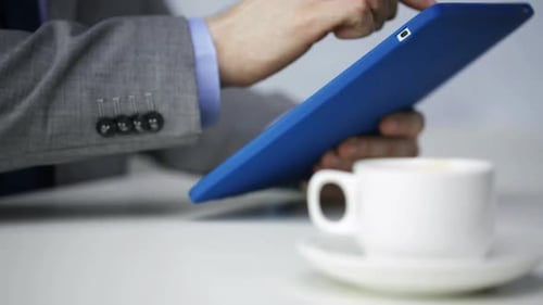 Closeup Of Businessman With Tablet Pc Computer Drinking Coffee At Office