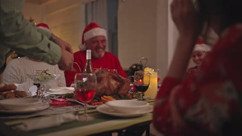 Family Celebrates Christmas Dinner Together at Home