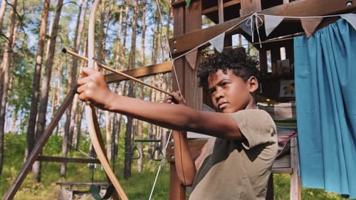 African American Boy Shooting Bow