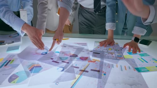 Teamwork and Collaboration Professionals Brainstorming in a bright, modern office, with laptops,