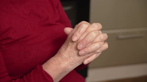 Intertwined Wrinkled Hands Close Up