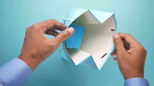 Putting a Present into a Light Blue Gift Bag