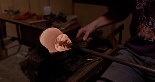 Glass Blower Shaping Molten Glass With Hand Tools