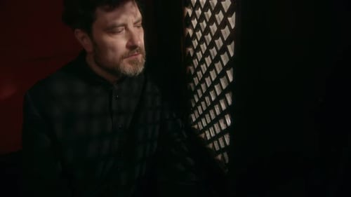 Priest Listening to Confession in Confessional Booth