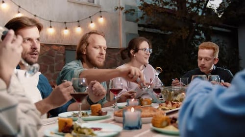 Friends Enjoying Outdoor Meal Together in Garden