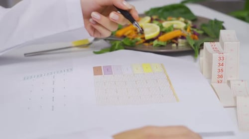 Dietitian is preparing a vegetable diet for her patients at the table.