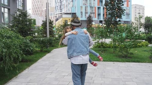 Loving Grandfather Carries Granddaughter in Urban Setting