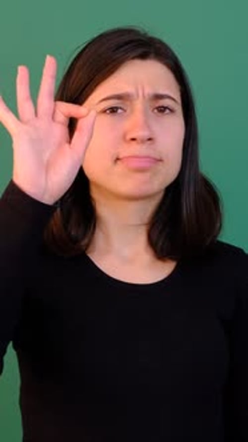 Woman Gives OK Sign in Front of Green Screen