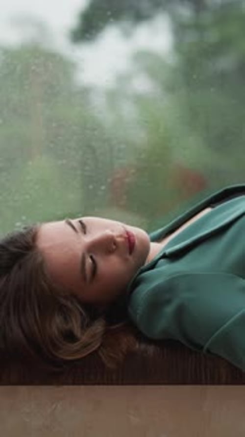 Woman Resting on Window Sill During Rain