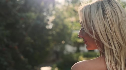 Portrait of a Caucasian Woman in Nature Near Green Trees