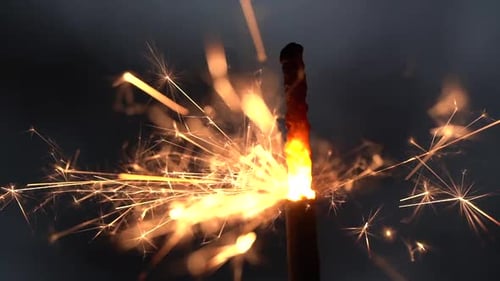 Burning Sparkler Creates Dazzling Effect on Dark Background