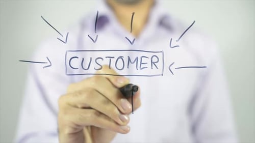 Man Writes Customer Diagram on Clear Screen